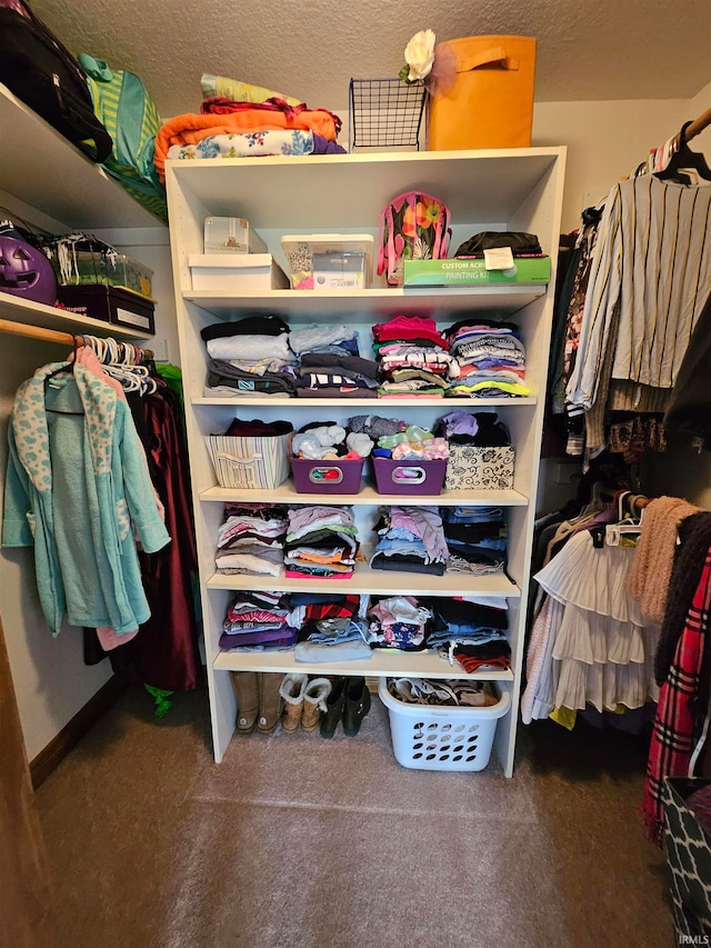 spacious closet featuring dark carpet