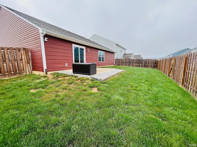 view of yard with central AC unit and a patio area