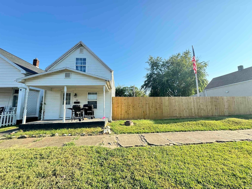 rear view of house with a yard