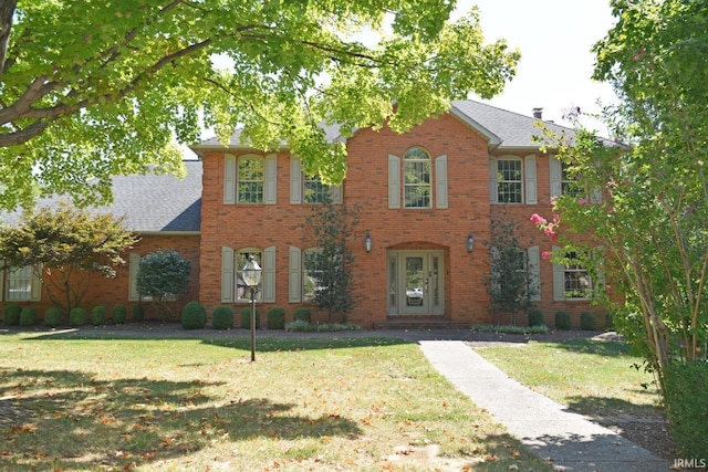 colonial-style house with a front yard