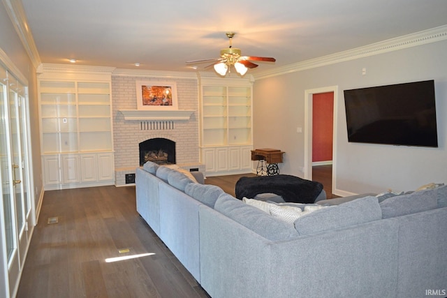 living room with ceiling fan, a fireplace, dark hardwood / wood-style flooring, and crown molding