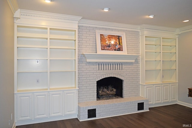 unfurnished living room with crown molding, dark hardwood / wood-style flooring, and a fireplace