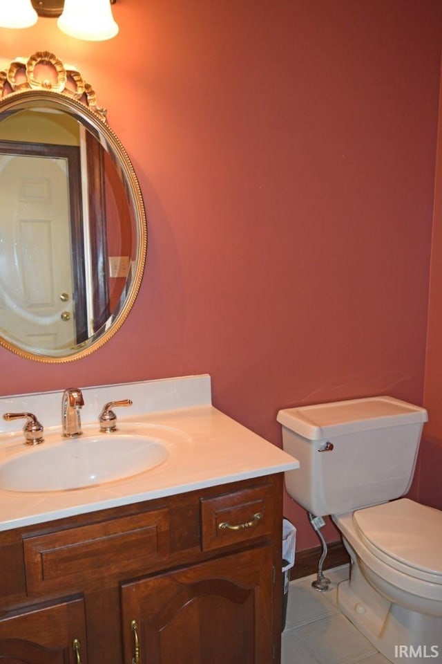 bathroom featuring vanity, toilet, and tile patterned flooring