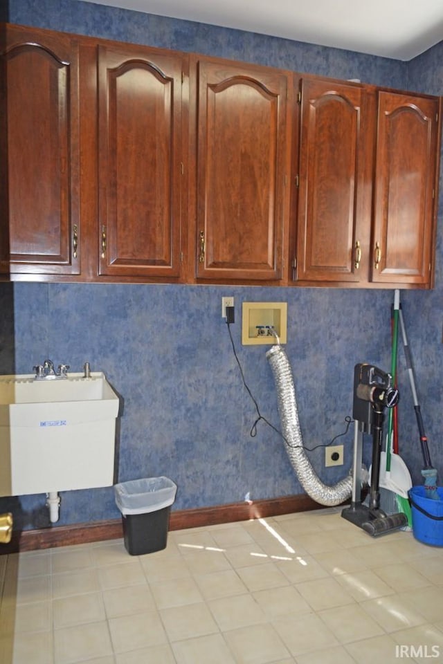 washroom with hookup for a washing machine, cabinets, sink, and tile patterned floors