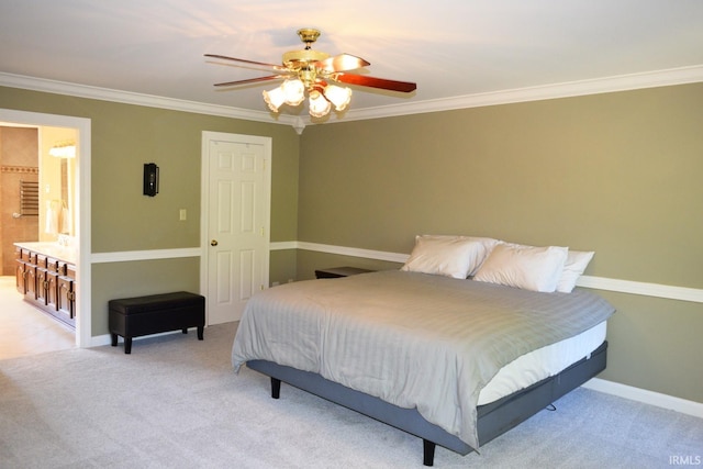 carpeted bedroom featuring ceiling fan, ornamental molding, and ensuite bath