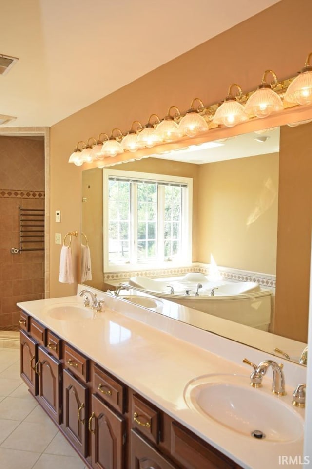 bathroom featuring tile patterned floors, a bath, and vanity