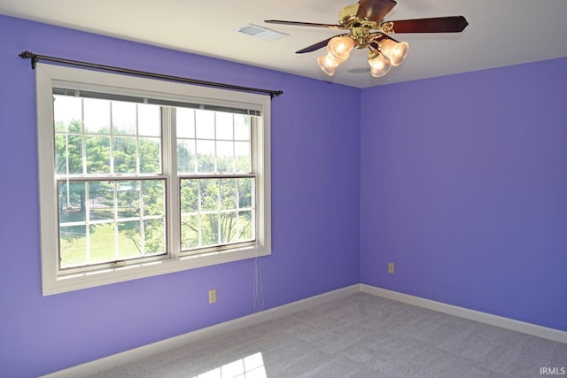 spare room featuring carpet flooring and ceiling fan