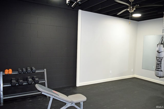 exercise room featuring concrete floors and ceiling fan