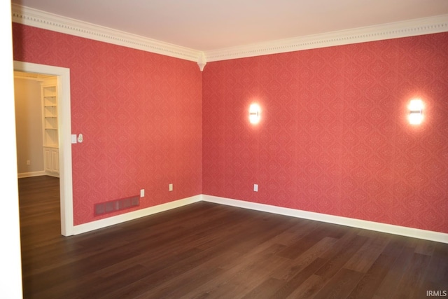 spare room with crown molding and dark hardwood / wood-style floors