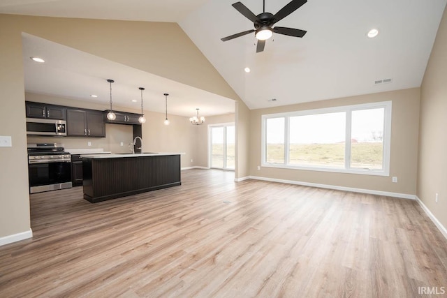 kitchen featuring sink, an island with sink, light hardwood / wood-style flooring, appliances with stainless steel finishes, and ceiling fan