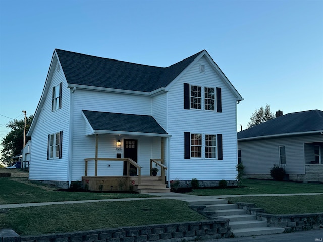 view of front of property with a porch and a front lawn