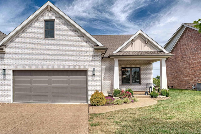 view of front of property featuring a garage, a front yard, and central air condition unit