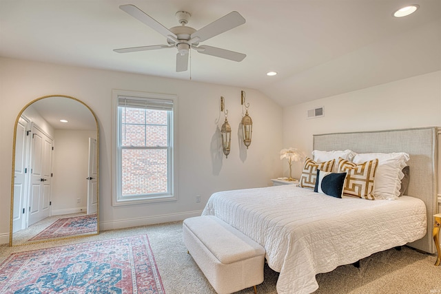 bedroom featuring lofted ceiling, light colored carpet, and ceiling fan