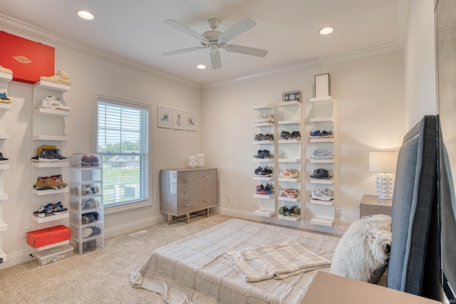 bedroom featuring crown molding, light colored carpet, and ceiling fan