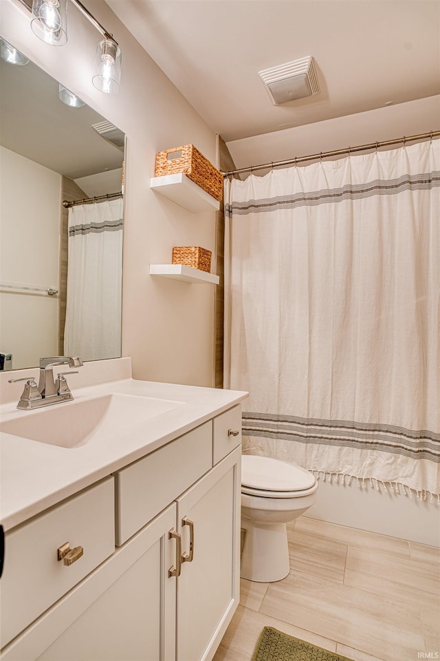 bathroom featuring vanity, toilet, and curtained shower