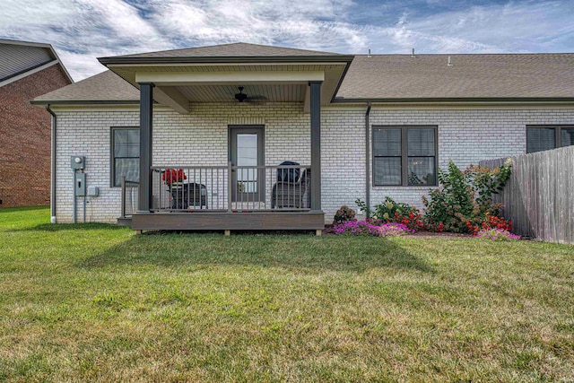 rear view of property with a yard