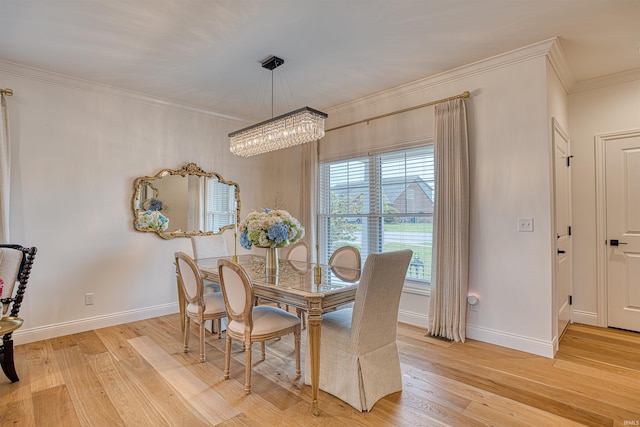 dining space with crown molding, light hardwood / wood-style flooring, and a chandelier