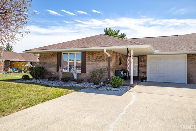 ranch-style house with a garage and a front lawn