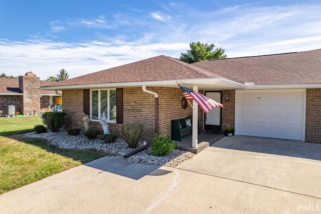 ranch-style home with an attached garage, brick siding, driveway, roof with shingles, and a front lawn