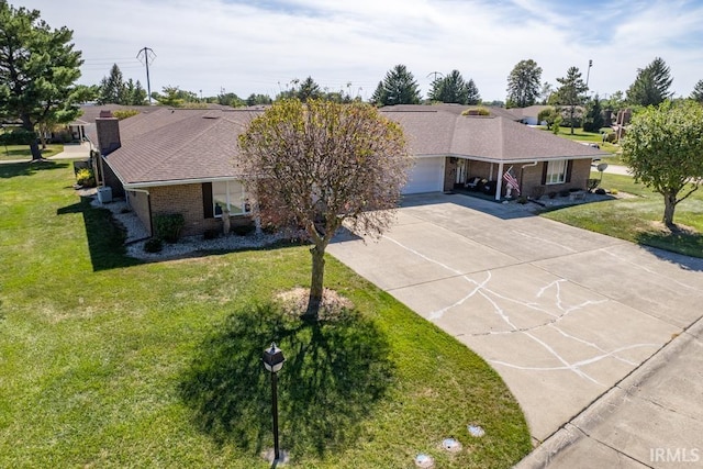 ranch-style house with a garage, concrete driveway, brick siding, and a front lawn