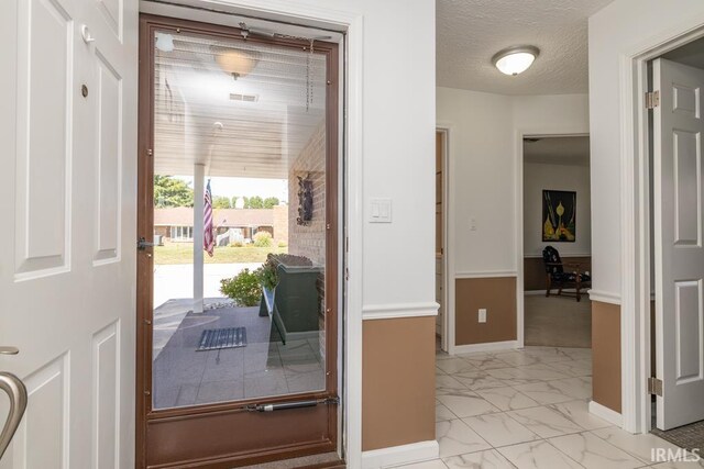 entryway featuring a textured ceiling