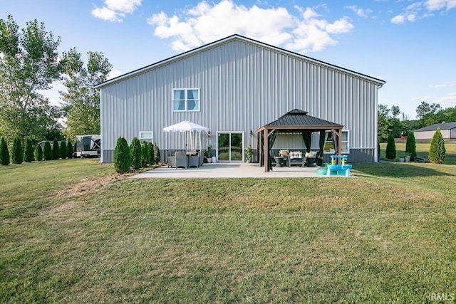 rear view of property featuring a patio area, a yard, and a gazebo