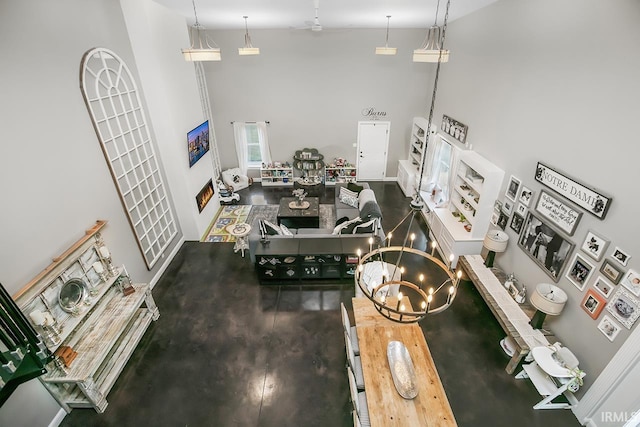 interior space with a towering ceiling and an inviting chandelier