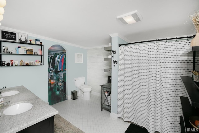 bathroom with tile patterned floors, toilet, ornamental molding, and vanity