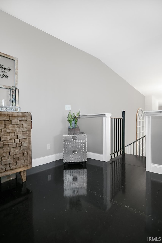 unfurnished living room featuring vaulted ceiling