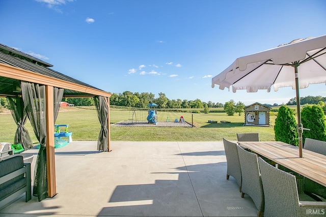 view of patio featuring a storage shed and a gazebo