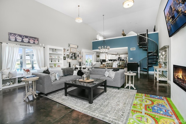 living room with high vaulted ceiling and a chandelier