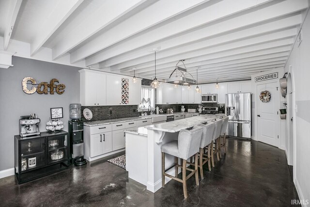 16084 County Road 20, Goshen, IN 46528 - kitchen with white cabinets, stainless steel appliances, tasteful backsplash, and beamed ceiling