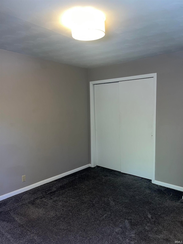 unfurnished bedroom with carpet and a closet