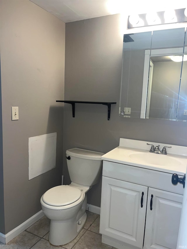 bathroom with vanity, toilet, and tile patterned flooring