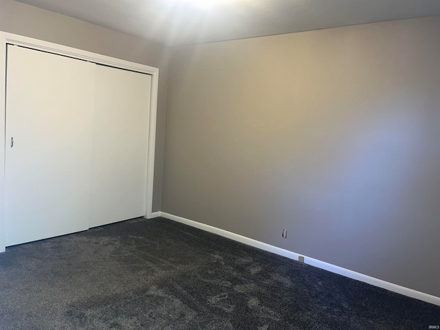 unfurnished bedroom featuring carpet flooring and a closet