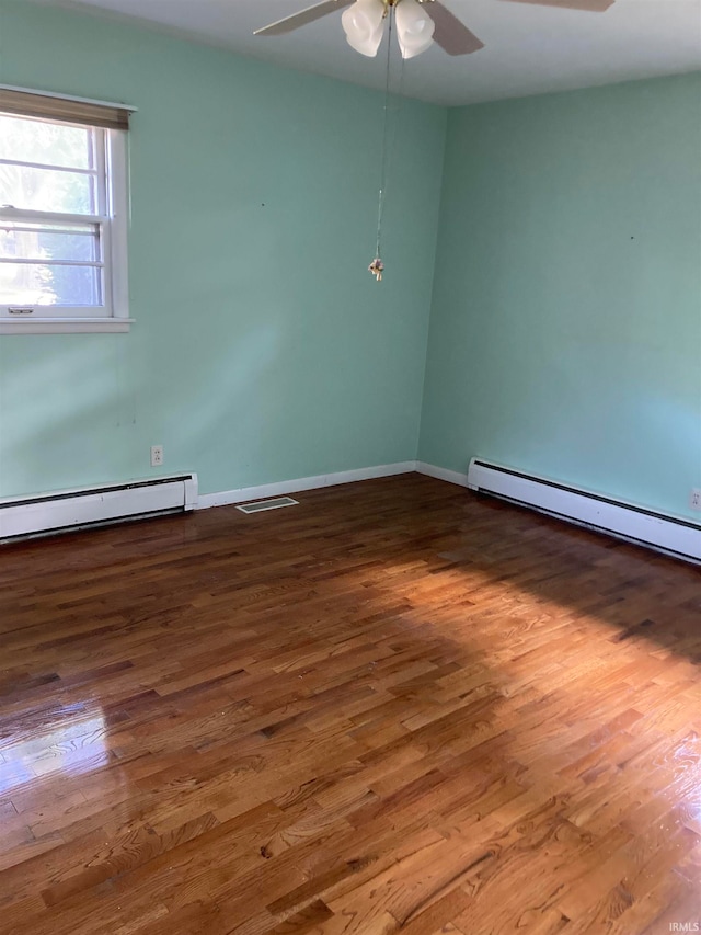 empty room featuring wood-type flooring, a baseboard radiator, and ceiling fan