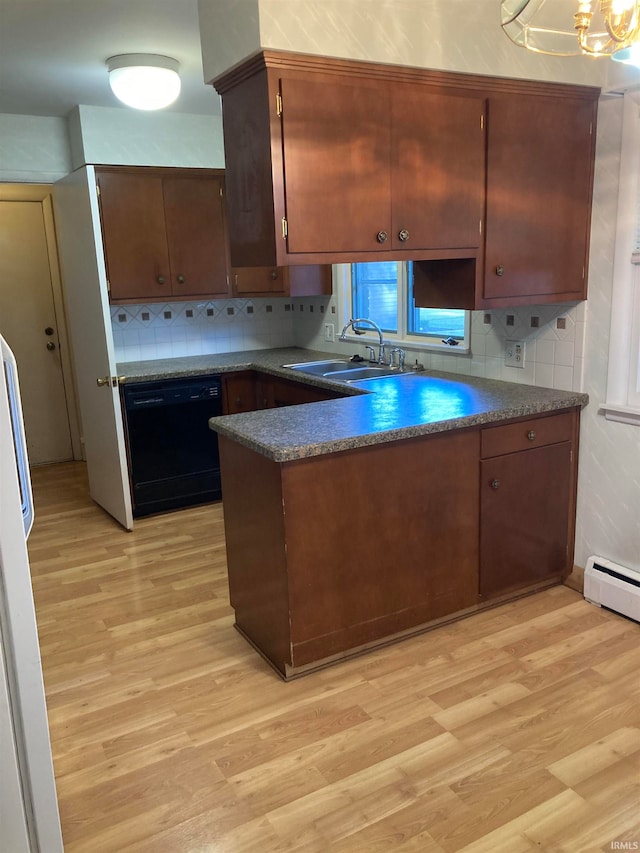 kitchen with black dishwasher, backsplash, sink, and light wood-type flooring