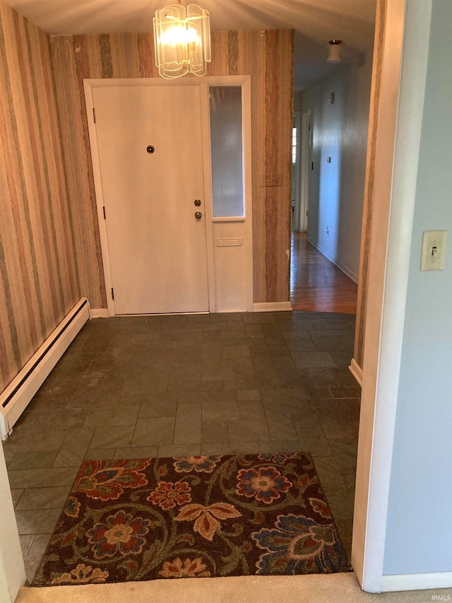 hall featuring a baseboard heating unit, a notable chandelier, and wooden walls