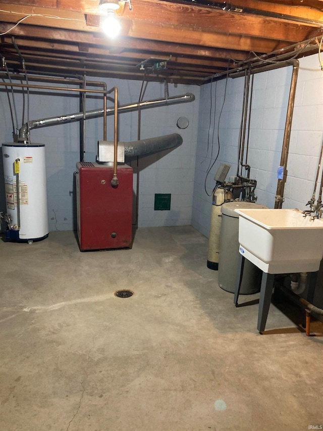 basement featuring gas water heater and sink