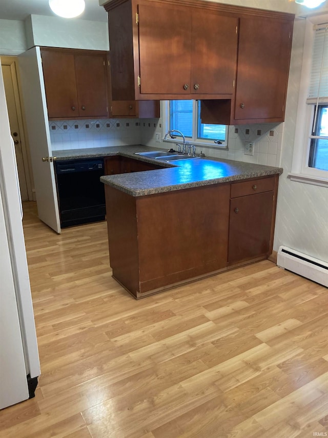 kitchen with light wood-type flooring, sink, black dishwasher, kitchen peninsula, and decorative backsplash