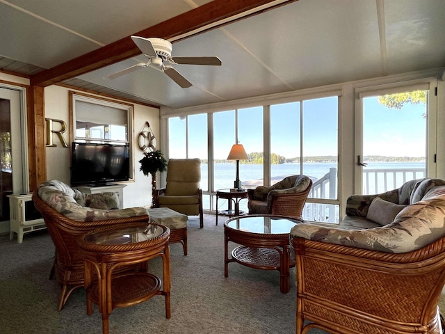 sunroom / solarium with a ceiling fan, a healthy amount of sunlight, a water view, and beamed ceiling