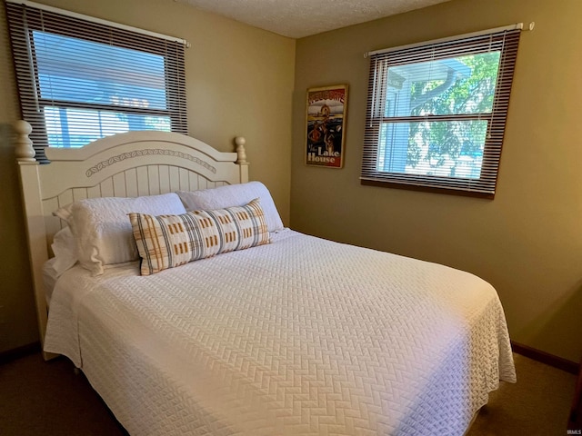 bedroom featuring a textured ceiling and carpet floors