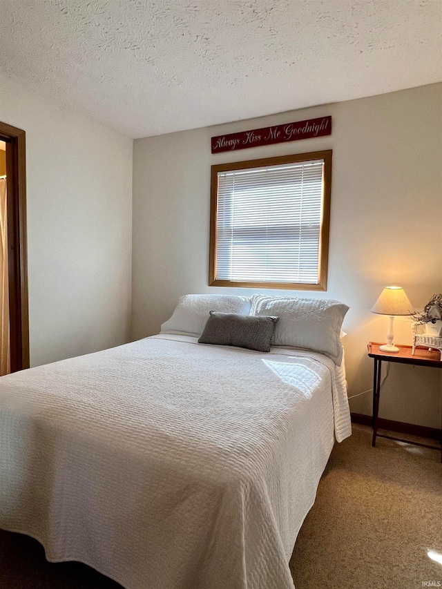 carpeted bedroom with a textured ceiling