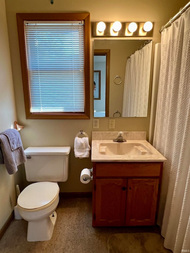 bathroom featuring vanity, toilet, and a shower with shower curtain