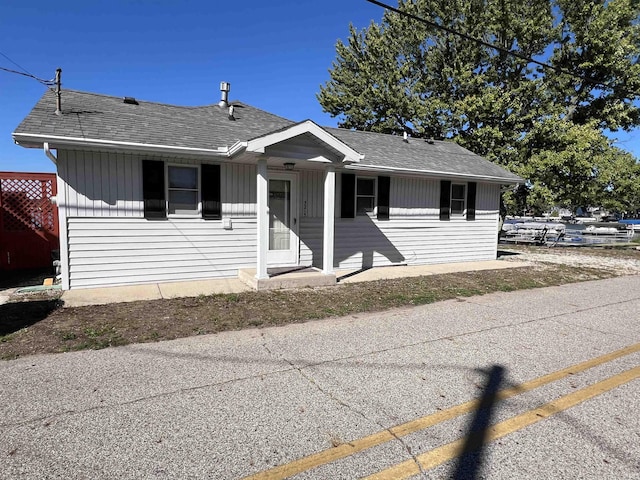 view of front of house featuring roof with shingles