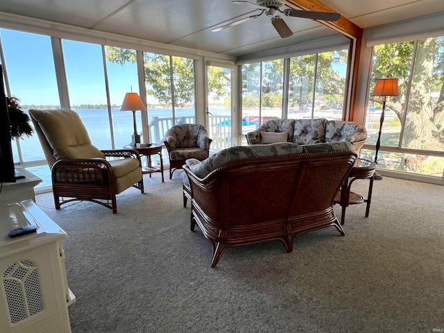 sunroom with a water view, ceiling fan, and plenty of natural light