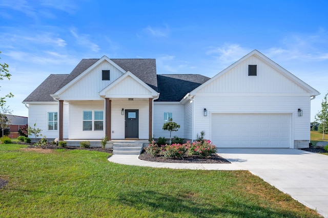 view of front of home with a front yard and a garage