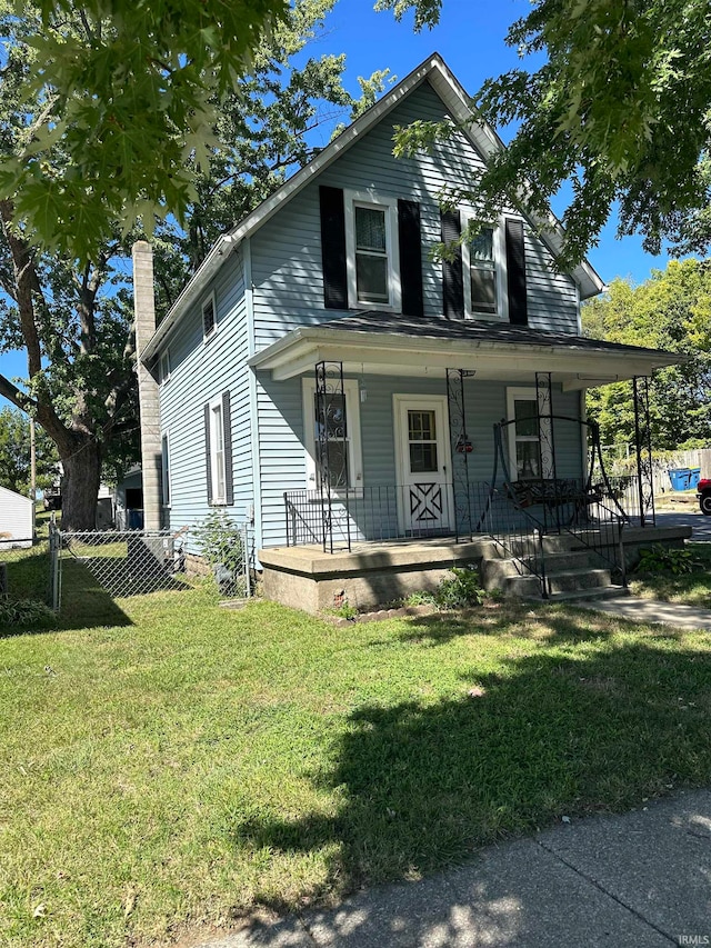 view of front of property with covered porch and a front yard