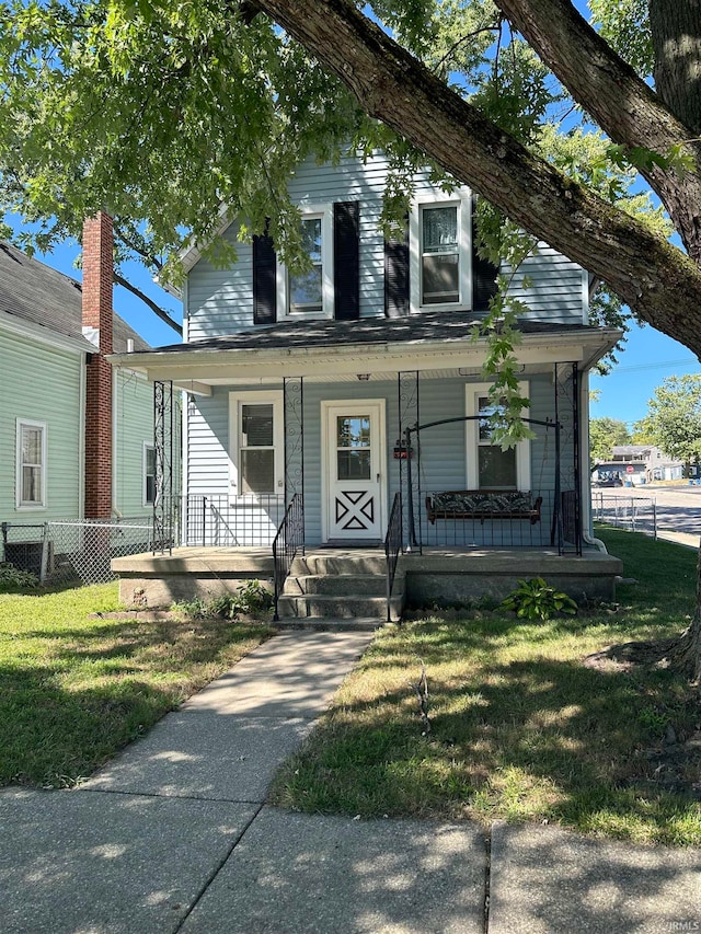 view of front of property featuring a front lawn and a porch