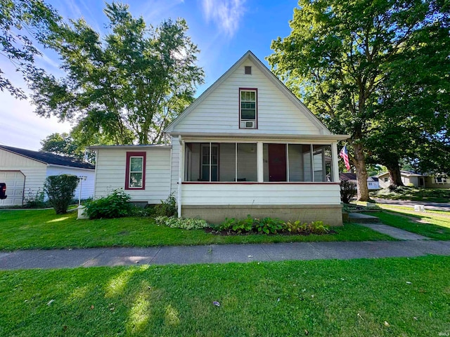 view of front of home featuring a sunroom and a front yard